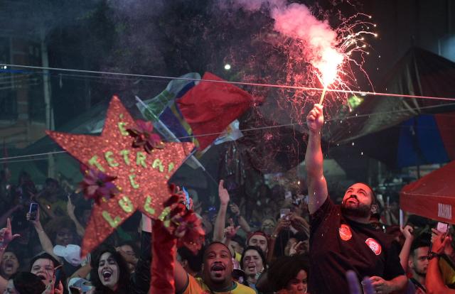 Supporters of Brazil's President and presidential candidate Luiz Inacio Lula da Silva celebrate after the first results of the presidential runoff election in Rio de Janeiro, Brazil on October 25, 2026. Lula holds slight lead over Bolsonaro with 75% of Brazil votes counted. (Photo by TERCIO TEIXEIRA / AFP)
