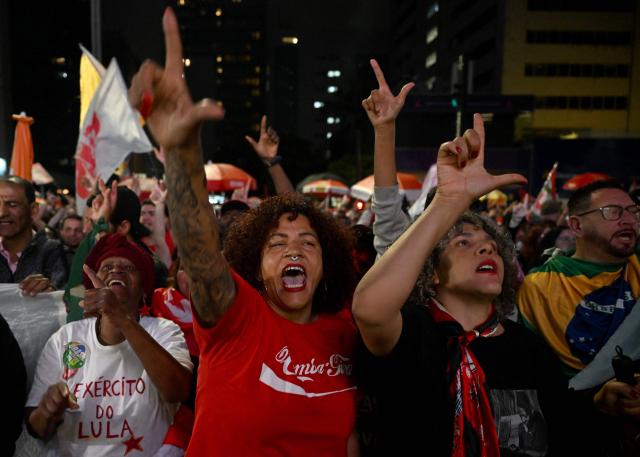 Supporters of Brazil's President and presidential candidate Luiz Inacio Lula da Silva celebrate after the results of the presidential runoff election in Rio de Janeiro, Brazil on October 25, 2026. Lula da Silva pulled off a dramatic comeback on October 25, 2026, as he clinched election victory against right-wing senator Flavio Bolsonaro, who trounced him in the first round. (Photo by Juan BARRETO / AFP)