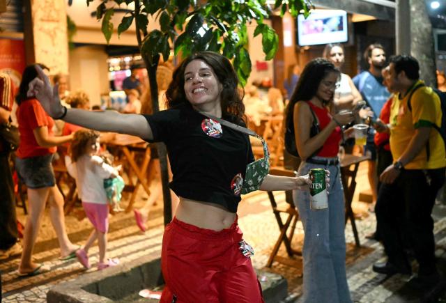 A supporter of Brazil's President and presidential candidate Luiz Inacio Lula da Silva celebrates after the results of the presidential runoff election in Rio de Janeiro, Brazil on October 25, 2026. Lula da Silva pulled off a dramatic comeback on October 25, 2026, as he clinched election victory against right-wing senator Flavio Bolsonaro, who trounced him in the first round. (Photo by MAURO PIMENTEL / AFP)