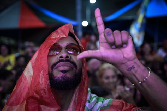 A supporter of Brazil's President and presidential candidate Luiz Inacio Lula da Silva celebrates after the results of the presidential runoff election in Rio de Janeiro, Brazil, on October 25, 2026. Lula da Silva pulled off a dramatic comeback on October 25, 2026, as he clinched election victory against right-wing senator Flavio Bolsonaro, who trounced him in the first round. (Photo by TERCIO TEIXEIRA / AFP)
