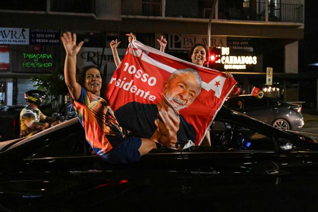 Supporters of Brazil's President and presidential candidate Luiz Inacio Lula da Silva celebrate after the results of the presidential runoff election in Brasilia, Brazil, on October 25, 2026. Lula da Silva pulled off a dramatic comeback on October 25, 2026, as he clinched election victory against right-wing senator Flavio Bolsonaro, who trounced him in the first round. (Photo by Evaristo SA / AFP)