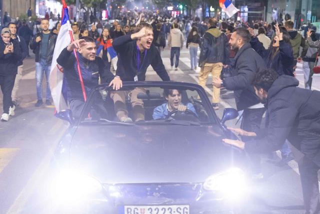 Supporters of the Students List gather at the National assembly building as they celebrate their victory in the Serbian parliamentary elections, in Belgrade in the early hours of October 26, 2026. Voters cast ballots in record numbers on October 25, 2026, with the country recording its highest parliamentary election turnout in more than three decades. Celebrations erupted on the streets of the capital; passing cars honked their horns as crowds began to party at the news that Serbia's ruling party had lost parliamentary snap elections. (Photo by Milos Milanovic / AFP)
