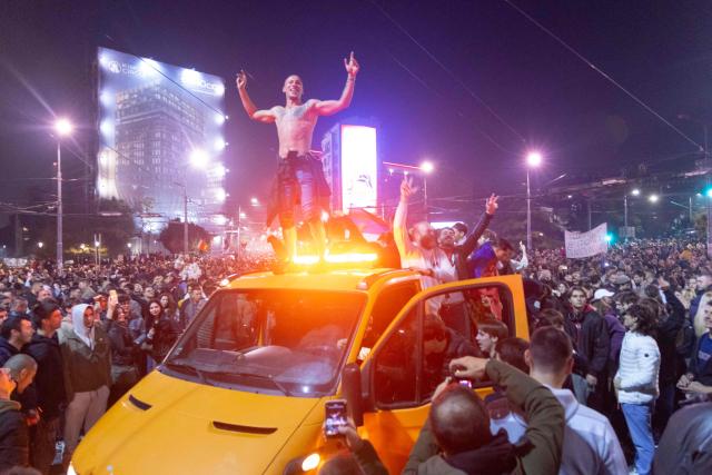 Supporters of the Students List gather at the National assembly building as they celebrate their victory in the Serbian parliamentary elections, in Belgrade in the early hours of October 26, 2026. Voters cast ballots in record numbers on October 25, 2026, with the country recording its highest parliamentary election turnout in more than three decades. Celebrations erupted on the streets of the capital; passing cars honked their horns as crowds began to party at the news that Serbia's ruling party had lost parliamentary snap elections. (Photo by Milos Milanovic / AFP)