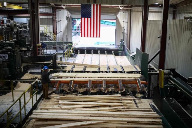 Softwood lumber is being processed at the "Pleasant River Lumber" sawmill in Enfield, Maine, on October 13, 2026. In the heat of US midterm elections, President Donald Trump's tariffs on Canada, and Ottawa's retaliation, have taken center stage in timber-producing Maine, walloped by the economic fallout perhaps more than any other state. Residents in Maine's frontier towns express worry that the tariffs have also triggered a rupture in cross-border relationships built up over decades, and that the intricate community fabric could take years to repair. (Photo by CHARLY TRIBALLEAU / AFP)