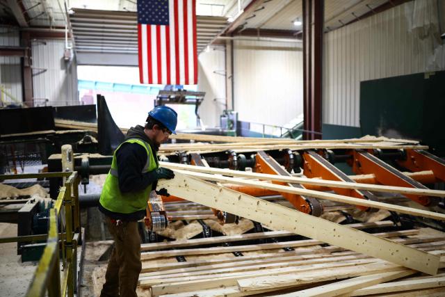 Softwood lumber is being processed at the "Pleasant River Lumber" sawmill in Enfield, Maine, on October 13, 2026. In the heat of US midterm elections, President Donald Trump's tariffs on Canada, and Ottawa's retaliation, have taken center stage in timber-producing Maine, walloped by the economic fallout perhaps more than any other state. Residents in Maine's frontier towns express worry that the tariffs have also triggered a rupture in cross-border relationships built up over decades, and that the intricate community fabric could take years to repair. (Photo by CHARLY TRIBALLEAU / AFP)