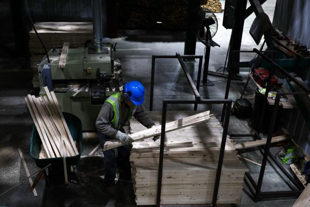 Softwood lumber is being processed at the "Pleasant River Lumber" sawmill in Enfield, Maine, on October 13, 2026. In the heat of US midterm elections, President Donald Trump's tariffs on Canada, and Ottawa's retaliation, have taken center stage in timber-producing Maine, walloped by the economic fallout perhaps more than any other state. Residents in Maine's frontier towns express worry that the tariffs have also triggered a rupture in cross-border relationships built up over decades, and that the intricate community fabric could take years to repair. (Photo by CHARLY TRIBALLEAU / AFP)