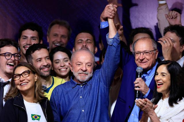 Brazil's President and re-election candidate for the Workers' Party (PT) Luiz Inacio Lula da Silva reacts next to his wife, First Lady Rosangela da Silva (L) and Vice President Geraldo Alckmin (2nd R) after knowing the first results of the presidential runoff election, in Sao Paulo, Brazil, on October 25, 2026. Lula da Silva pulled off a dramatic comeback on October 25, 2026, as he clinched election victory against right-wing senator Flavio Bolsonaro, who trounced him in the first round. (Photo by Miguel SCHINCARIOL / AFP)