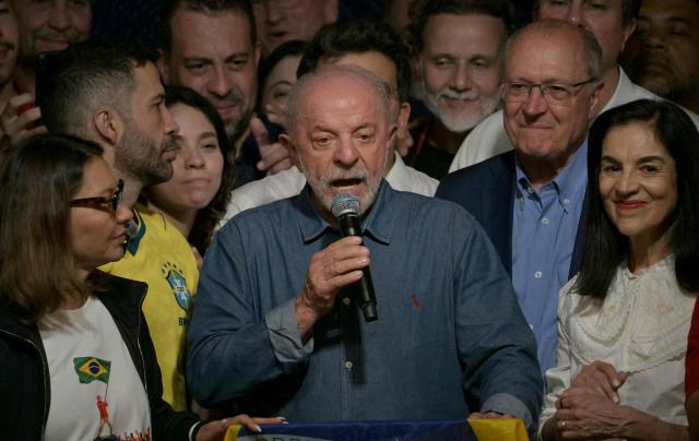 Brazil's President and re-election candidate for the Workers' Party (PT) Luiz Inacio Lula da Silva reacts next to his wife, First Lady Rosangela da Silva (L) and Vice President Geraldo Alckmin (2nd R) after knowing the first results of the presidential runoff election, in Sao Paulo, Brazil, on October 25, 2026. Lula da Silva pulled off a dramatic comeback on October 25, 2026, as he clinched election victory against right-wing senator Flavio Bolsonaro, who trounced him in the first round. (Photo by NELSON ALMEIDA / AFP)