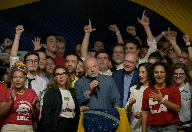 Brazil's President and re-election candidate for the Workers' Party (PT) Luiz Inacio Lula da Silva (C) reacts next to his wife, First Lady Rosangela da Silva (2nd L) and Vice President Geraldo Alckmin (3nd R) after knowing the first results of the presidential runoff election, in Sao Paulo, Brazil, on October 25, 2026. Lula da Silva pulled off a dramatic comeback on October 25, 2026, as he clinched election victory against right-wing senator Flavio Bolsonaro, who trounced him in the first round. (Photo by NELSON ALMEIDA / AFP)