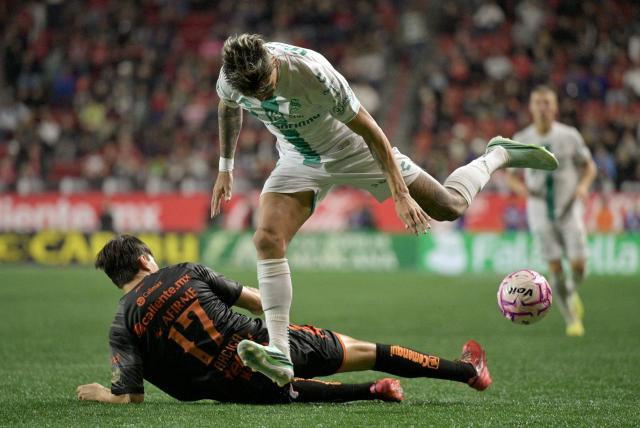 Santos' Paraguayan forward #07 Diego Gonzalez and Tijuana's forward #17 Ramiro Arciga fight for the ball during the Liga MX Apertura tournament football match between Tijuana and Santos Laguna at the Caliente satdium, in Tijuana, Baja California, Mexico on October 25, 2026. (Photo by Guillermo Arias / AFP)