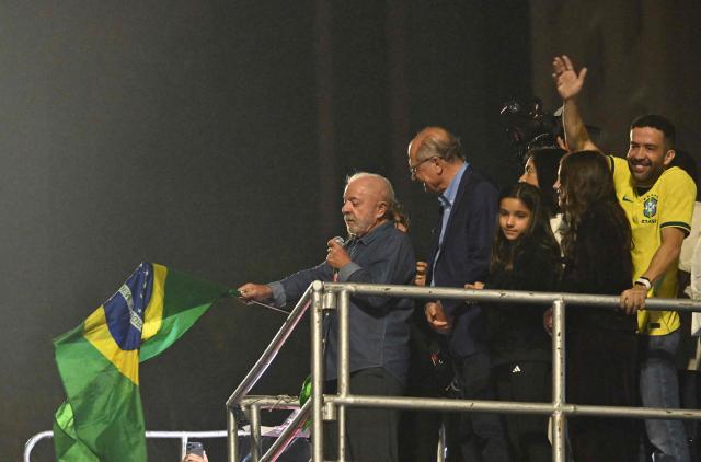 Brazil's President and presidential candidate Luiz Inacio Lula da Silva waves a Brazilian flag as he delivers a speech to supporters after winning the presidential runoff election in Sao Paulo, Brazil, on October 25, 2026. Lula da Silva pulled off a dramatic comeback on October 25, 2026, as he clinched election victory against right-wing senator Flavio Bolsonaro, who trounced him in the first round. (Photo by Juan BARRETO / AFP)