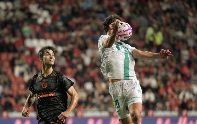Tijuana's Spanish defender #04 Unai Bilbao and Santos' forward #20 Esteban Lozano fight for the ball during the Liga MX Apertura tournament football match between Tijuana and Santos Laguna at the Caliente satdium, in Tijuana, Baja California, Mexico on October 25, 2026. (Photo by Guillermo Arias / AFP)
