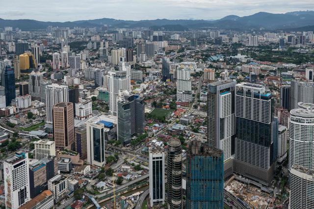 Commercial buildings are seen through clear skies as haze conditions due to Indonesian wildfires improve in Kuala Lumpur on October 26, 2026. The haze has sent air pollution levels surging to dangerous levels not only in Indonesia, but also in Malaysia, Singapore and East Timor, prompting the ASEAN regional bloc to call a meeting over the crisis. (Photo by MOHD RASFAN / AFP)