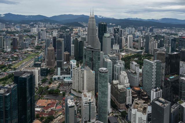 Malaysia's Petronas Twin Towers and commercial buildings are seen through clear skies as haze conditions due to Indonesian wildfires improve in Kuala Lumpur on October 26, 2026. The haze has sent air pollution levels surging to dangerous levels not only in Indonesia, but also in Malaysia, Singapore and East Timor, prompting the ASEAN regional bloc to call a meeting over the crisis. (Photo by Mohd Rasfan / AFP)