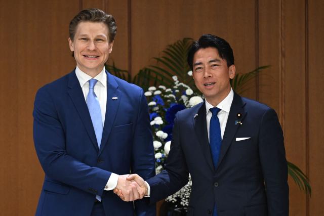 Finland's Defence Minister Antti Hakkanen (R) and Japan's Defence Minister Shinjiro Koizumi shake hands ahead of their meeting at the Ministry of Defence in Tokyo on October 26, 2026. (Photo by Rie KIKUCHI / AFP)