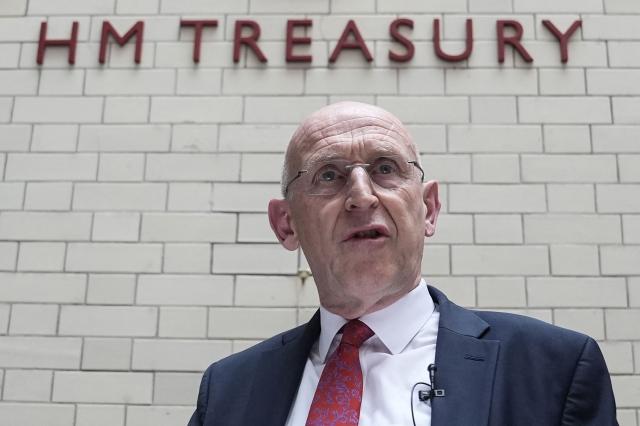(FILES) Britain's newly appointed Chancellor of the Exchequer John Healey gives his first all staff address at HM Treasury in central London on July 21, 2026. British Prime Minister Andy Burnham's new government unveils its first budget on October 28, 2026, testing a commitment to ease the cost of living and ramp up defence spending with little financial room for manoeuvre. It could prove to be a tall order for Finance Minister John Healey as rising inflation and borrowing costs -- largely a consequence of the US-Iran war -- increase the government's debt pile and heap pressure on businesses and individuals. (Photo by Stefan Rousseau / POOL / AFP)