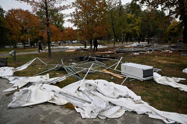 Street cleaning workers clear away the remains of tents and rubbish from a pro-government encampment in a park opposite the Serbian Parliament in Belgrade on October 26, 2026, after crowds celebrating election results entered the site the previous night and dismantled tents that had occupied the area for months, setting them alight along with a number of cars. Serbia's student-led movement declared victory in parliamentary elections on October 25 ending 14 years in power for Aleksandar Vucic's right-wing populist party. The victory in the snap vote comes after nearly two years of anti-government protests sparked by the 2024 collapse of a canopy at Novi Sad railway station that killed 16 people. The disaster has been widely blamed on corruption and triggered some of Serbia's largest protests since the fall of strongman Slobodan Milosevic in 2000. (Photo by Andrej ISAKOVIC / AFP)
