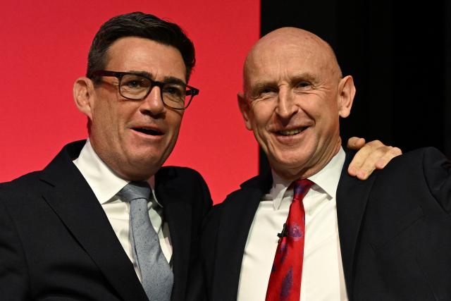 (FILES) Britain's Prime Minister Andy Burnham (L) congratulates Britain's Chancellor of the Exchequer John Healey after he delivered a speech on the second day of the annual Labour Party conference in Liverpool, north-west England, on September 28, 2026. British Prime Minister Andy Burnham's new government unveils its first budget on October 28, 2026, testing a commitment to ease the cost of living and ramp up defence spending with little financial room for manoeuvre. It could prove to be a tall order for Finance Minister John Healey as rising inflation and borrowing costs -- largely a consequence of the US-Iran war -- increase the government's debt pile and heap pressure on businesses and individuals. (Photo by Oli SCARFF / AFP)