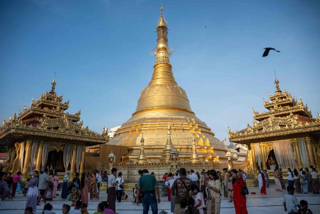 Buddhist devotees visit Botahtaung Pagoda during the Full Moon Day of the Thadingyut Festival in Yangon on October 26, 2026. Thousands of Buddhist devotees flocked to pagodas across the city to pray, make merits, and participate in the annual festival of lights marking the end of Buddhist Lent. (Photo by Sai Aung MAIN / AFP)