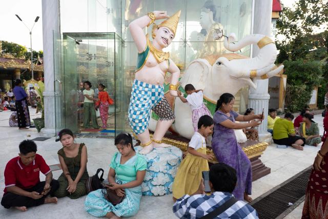 Buddhist devotees visit Botahtaung Pagoda during the Full Moon Day of the Thadingyut Festival in Yangon on October 26, 2026. Thousands of Buddhist devotees flocked to pagodas across the city to pray, make merits, and participate in the annual festival of lights marking the end of Buddhist Lent. (Photo by Sai Aung MAIN / AFP)