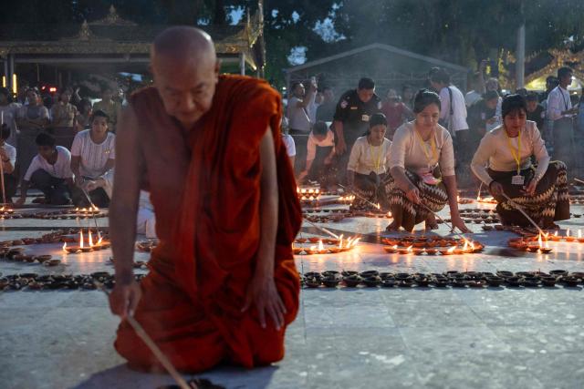 Buddhist devotees light traditional earthenware oil lamps at Botahtaung Pagoda during the Full Moon Day of the Thadingyut Festival in Yangon on October 26, 2026. Thousands of Buddhist devotees flocked to pagodas across the city to pray, make merits, and participate in the annual festival of lights marking the end of Buddhist Lent. (Photo by Sai Aung MAIN / AFP)