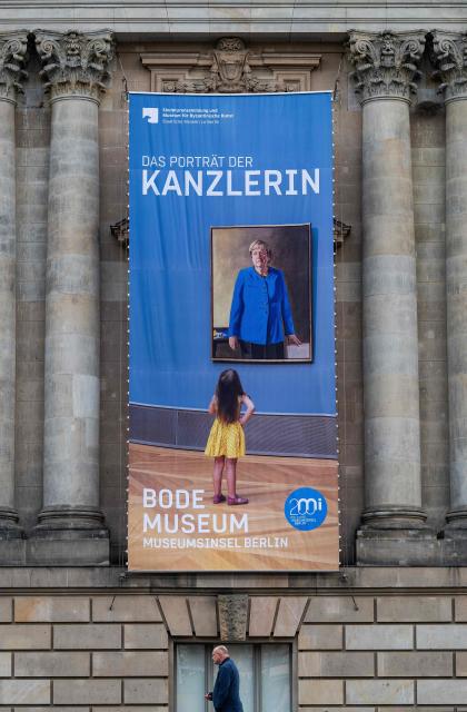 A banner advertises the portrait of former German chancellor Angela Merkel, on display at Berlin's Bode museum on October 26, 2026. The portrait, which has been a magnet for museum goers, will be on display at the museum until January 2027. (Photo by John MACDOUGALL / AFP)