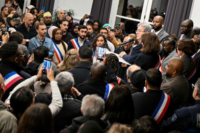 Leftist party La France Insoumise (LFI) candidate in France's 2027 presidential election Jean-Luc Melenchon delivers a speak during a gathering in the town hall of the Paris suburban city of La Courneuve on October 26, 2026, to pay tribute to the victims of the October 23 racist shooting that killed one person and wounded five in Trappes. Marches were held on October 25 in tribute to the man killed in the shooting, Pengo Bossio Wangi, a 26-year-old French national of Congolese origin, and more were planned for today in several French cities, including Paris. (Photo by LOU BENOIST / AFP)
