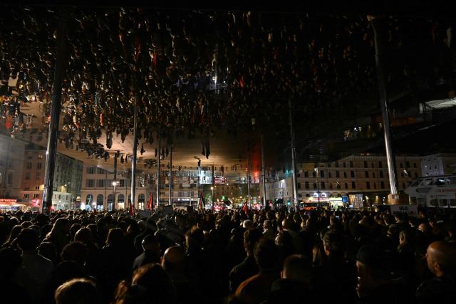 People take part in a tribute to the victims of the Trappes attacks, in the Old Port in Marseille, on October 26, 2026. A man suspected of a gun attack in the Paris suburbs that killed Pengo Bossio Wangi and wounded five other persons has left custody and been placed in a psychiatric unit for observation, French anti-terror prosecutors said on October 25, 2026. The 39-year-old suspect, partly identified as Kevin T., was arrested on October 23, in possession of a submachine gun and tear-gas grenades in his car, shortly after the victims were shot as a vehicle drove through the working-class town of Trappes and neighbouring La Verriere. (Photo by Justine MEDDAH / AFP)