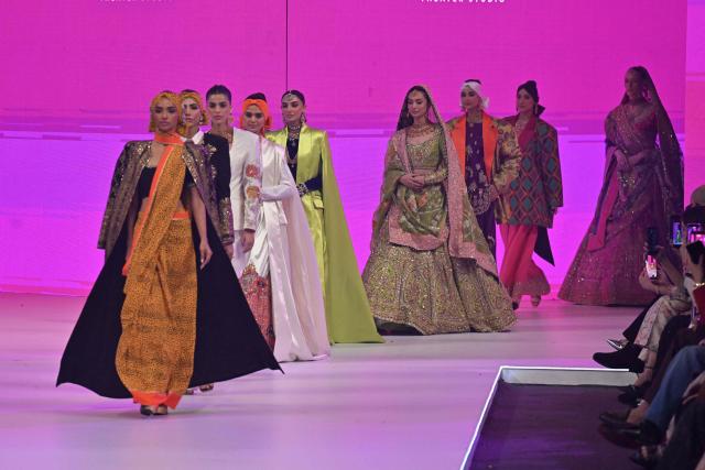 Models present creations by fashion designer Ail Xeeshan during the LAAM Fashion Week in Lahore on October 26, 2026. (Photo by Arif ALI / AFP)