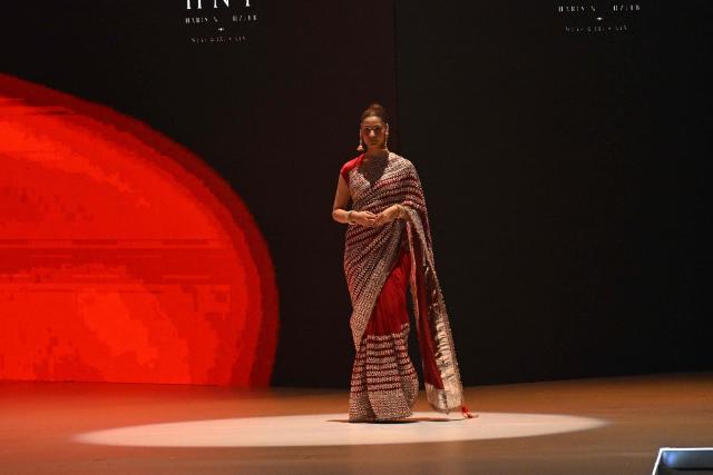 A model presents a creation by fashion designer Haris N Tehzeeb during the LAAM Fashion Week in Lahore on October 26, 2026. (Photo by Arif ALI / AFP)