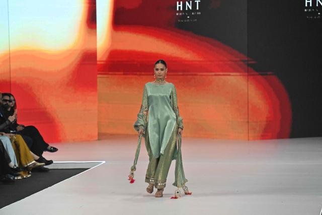 A model presents a creation by fashion designer Haris N Tehzeeb during the LAAM Fashion Week in Lahore on October 26, 2026. (Photo by Arif ALI / AFP)