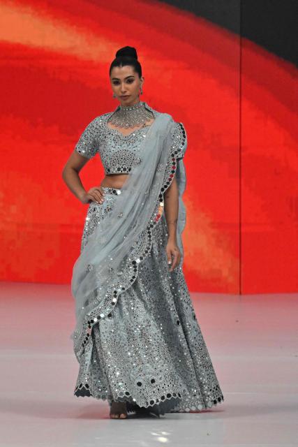 A model presents a creation by fashion designer Haris N Tehzeeb during the LAAM Fashion Week in Lahore on October 26, 2026. (Photo by Arif ALI / AFP)
