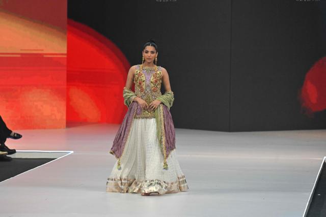 A model presents a creation by fashion designer Haris N Tehzeeb during the LAAM Fashion Week in Lahore on October 26, 2026. (Photo by Arif ALI / AFP)