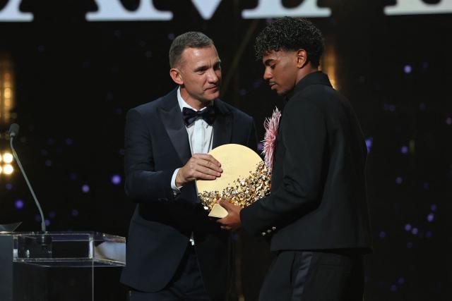 Former Ukraine forward Andriy Shevchenko presents the Trophy for the Men's Young Talent of the Year to Spain and Barcelona forward Lamine Yamal during the 2026 Ballon d'Or France Football award ceremony at the Palladium Theatre in London on October 26, 2026. (Photo by FRANCK FIFE / AFP)