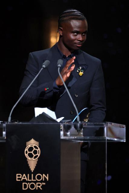 English fooballer Bukayo Saka speaks after being awarded the Socrates Trophy for most involved player in societal and charitable projects during the 2026 Ballon d'Or France Football award ceremony at the Palladium Theatre in London on October 26, 2026. (Photo by FRANCK FIFE / AFP)