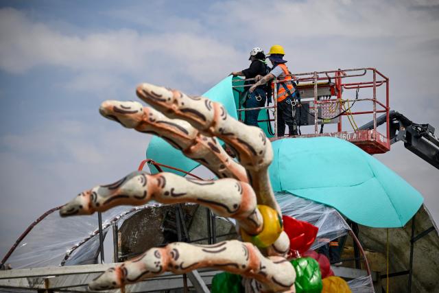 Workers prepare the massive Day of the Dead altar at the Zocalo square in Mexico City on October 26, 2026, ahead of its unveiling on October 29. On November 2, Mexicans celebrate the Day of the Dead, a tradition honoring deceased relatives and loved ones. (Photo by Alfredo ESTRELLA / AFP)