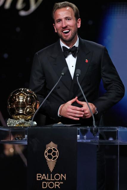 England and Bayern Munich forward Harry Kane smiles after receiving the Ballon d'Or award for the best male footballer during the 2026 Ballon d'Or France Football award ceremony at the Palladium Theatre in London on October 26, 2026. (Photo by FRANCK FIFE / AFP)