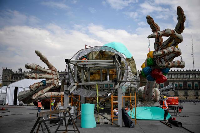 Workers prepare the massive Day of the Dead altar at the Zocalo square in Mexico City on October 26, 2026, ahead of its unveiling on October 29. On November 2, Mexicans celebrate the Day of the Dead, a tradition honoring deceased relatives and loved ones. (Photo by Alfredo ESTRELLA / AFP)