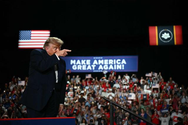 US President Donald Trump points as he walks on stage to speak at a midterm campaign rally at Crossroads Arena in Corinth, Mississippi on October 26, 2026. President Trump is holding the campaign rally to support the re-election campaign of US Senatory Cindy Hyde-Smith (R-MS). (Photo by Kent NISHIMURA / AFP)