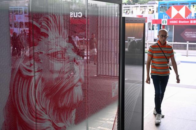 A pedestrian walks outside the HSBC bank headquarters in Hong Kong on October 27, 2026, ahead of the bank's third quarter results announcement. (Photo by Peter PARKS / AFP)