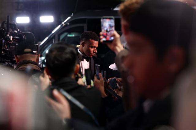 (FILES) France and Real Madrid forward Kylian Mbappe arrives to attend the 2026 Ballon d'Or France Football award ceremony at the Palladium Theatre in London on October 26, 2026. China's biggest energy drink brand said October 27, 2026 it has cancelled a partnership with Kylian Mbappe after a video circulated online in which the French football star apparently joked about former leader Mao Zedong. (Photo by FRANCK FIFE / AFP)