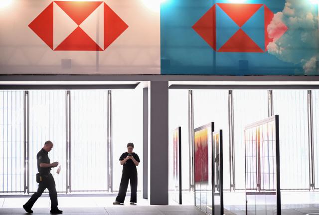People are seen at the HSBC bank headquarters in Hong Kong on October 27, 2026, ahead of the bank's third quarter results announcement. Banking giant HSBC said October 27 that net profit in the third quarter rose 45.5 percent year-on-year as the London-headquartered lender continues to restructure operations and cut costs, falling short of market consensus. (Photo by Peter PARKS / AFP)
