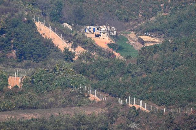 A North Korean guard post and military fences on the North side of the Demilitarised Zone (DMZ) dividing the two Koreas, are seen from a South Korean observation deck at Aegibong Peace Ecopark in Gimpo on October 27, 2026. (Photo by Jung Yeon-je / AFP)
