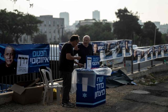 Supporters of the Yashar party, led by Gadi Eisenkot, wait outside a polling station in Jerusalem on October 27, 2026, on the day of Israel's legislative election. A deeply divided Israel heads to the polls on October 27 for the first time since Hamas's October 7, 2023 attack, with voters delivering their verdict on veteran Prime Minister Benjamin Netanyahu and the country's rightward drift. (Photo by Jewel SAMAD / AFP)