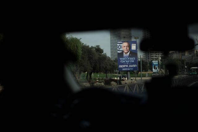 A taxi driver steers past an electoral billboard of the Yashar party, led by Gadi Eisenkot, in Jerusalem on October 27, 2026, on the day of Israel's legislative election. A deeply divided Israel heads to the polls on October 27 for the first time since Hamas's October 7, 2023 attack, with voters delivering their verdict on veteran Prime Minister Benjamin Netanyahu and the country's rightward drift. (Photo by Jewel SAMAD / AFP)