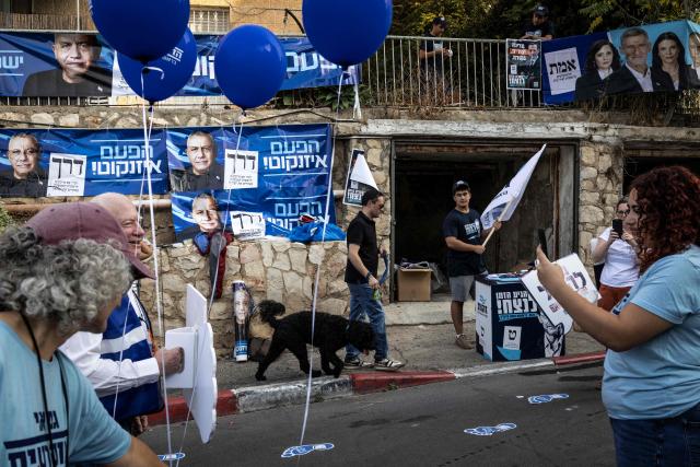 Volunteers set up election campaign posters outside a polling station in Jerusalem on October 27, 2026, on the day of Israel's legislative election. A deeply divided Israel heads to the polls on October 27 for the first time since Hamas's October 7, 2023 attack, with voters delivering their verdict on veteran Prime Minister Benjamin Netanyahu and the country's rightward drift. (Photo by John WESSELS / AFP)