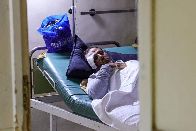 EDITORS NOTE: Graphic content / A Syrian man is seen on a stretcher after he was wounded in airstrikes carried out by Jordan on the village of Al-Taf in the Al-Lajat region, located in the northeastern countryside of Daraa, on october 27, 2026. Syrian authorities said at least six people were killed in strikes on October 26 in the country's south, as Jordan said it had targeted "terrorist organisations" after a deadly jihadist attack on a church. In an updated statement, health authorities in Daraa province reported "six martyrs, including three children and a woman", after earlier reporting eight victims. (Photo by Bakr ALkasem / AFP)
