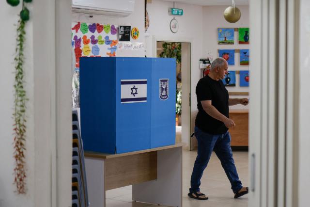 A member of the Druze community casts his ballot at a polling station in the Druze village of Ein Qiniye, in the Israeli-annexed Golan Heights, on October 27, 2026, on the day of Israel's legislative election. (Photo by Jalaa MAREY / AFP)