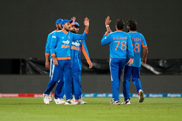 India's players celebrate catching New Zealand Finn Allen during the 3rd T20 cricket match between New Zealand and India at the HNRY Stadium in Wellington on October 27, 2026. (Photo by Marty MELVILLE / AFP)