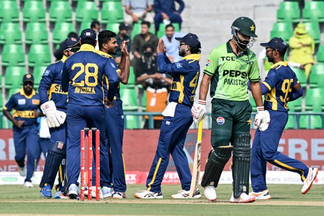 Sri Lanka's players celebrate after the dismissal of Pakistan's Fakhar Zaman (2R) during the one-day international (ODI) tri-series cricket match between Pakistan and Sri Lanka at the Gaddafi Stadium in Lahore on October 27, 2026. (Photo by ARIF ALI / AFP)